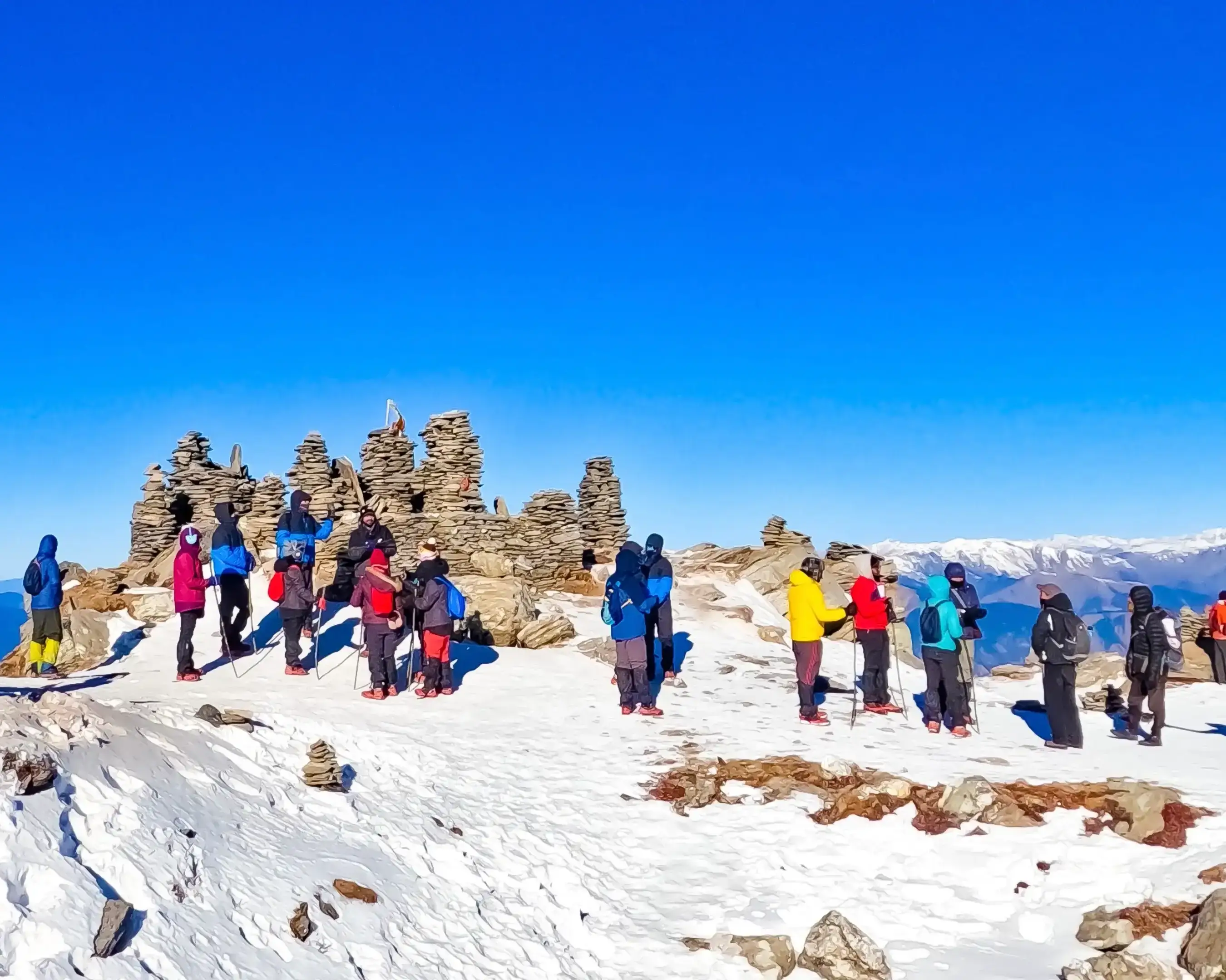 Trekkers ascending Kedarkantha in snow